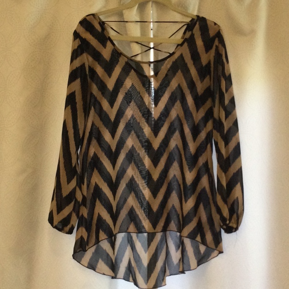 Sheer blouse with chevron design and high low hem.